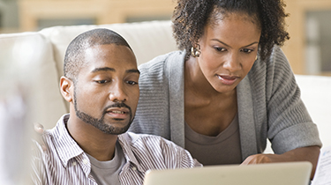 Man and woman looking at a laptop