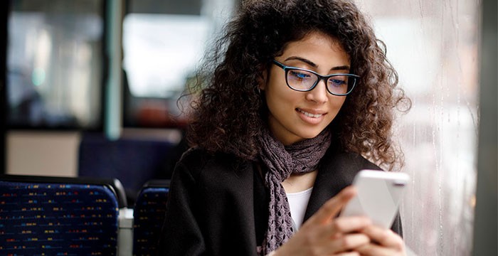 Woman on a bus using her phone